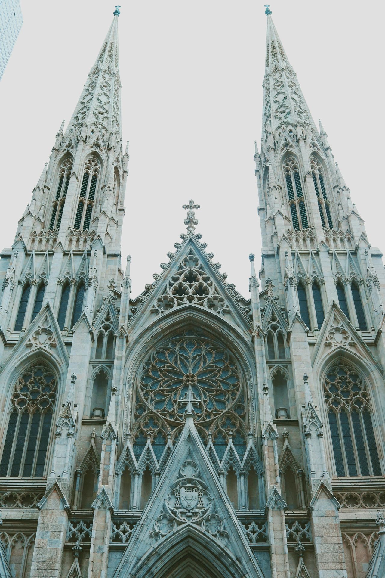 St. Joseph’s Cathedral in Hanoi, Vietnam – Gothic-style church facade with twin bell towers, large cross, and golden Virgin Mary statue in front.